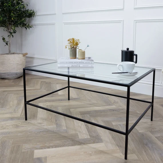 Minimalist coffee table with glass top and silver frame